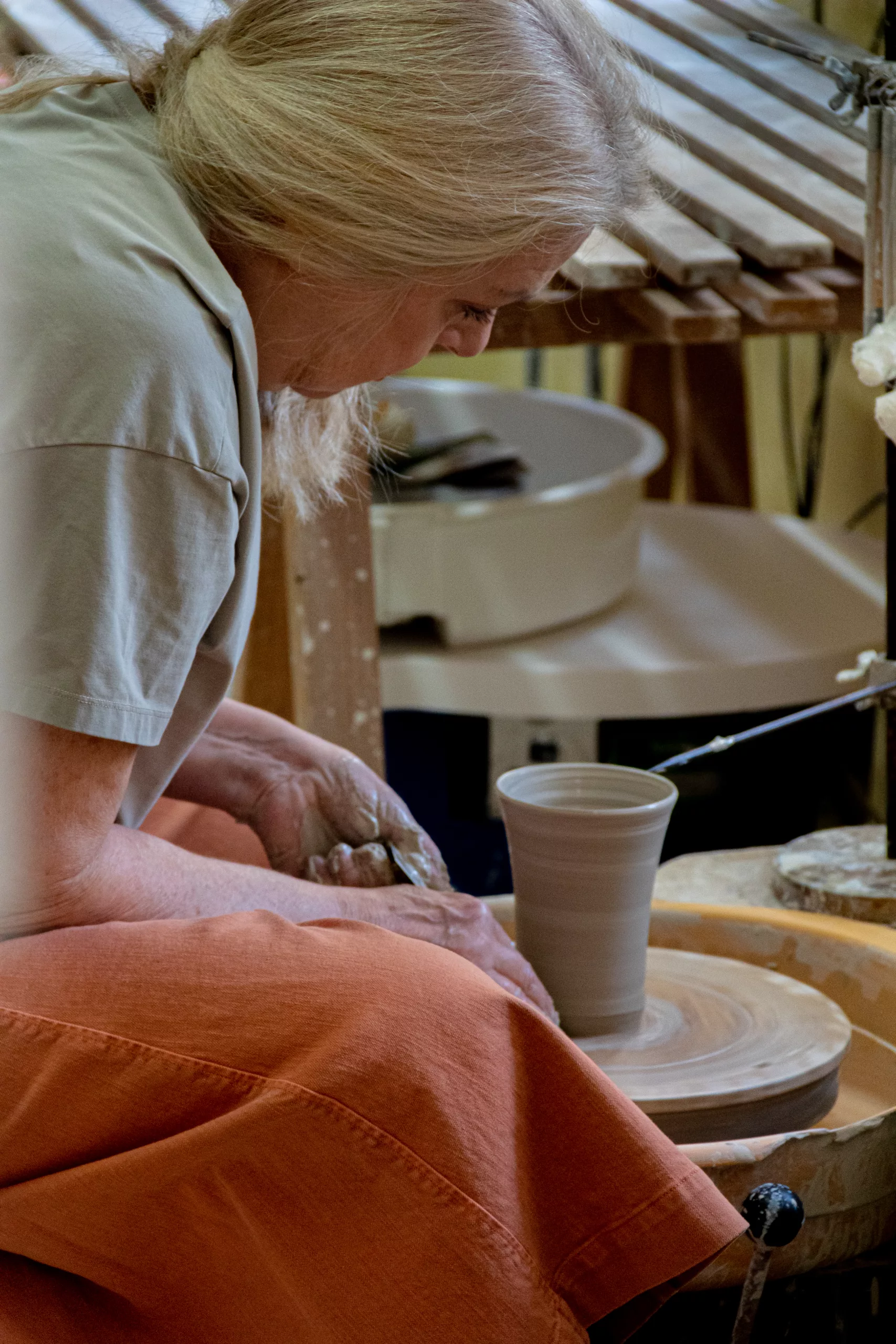 Suzanne Bühler shaping a cup on the potter's wheel