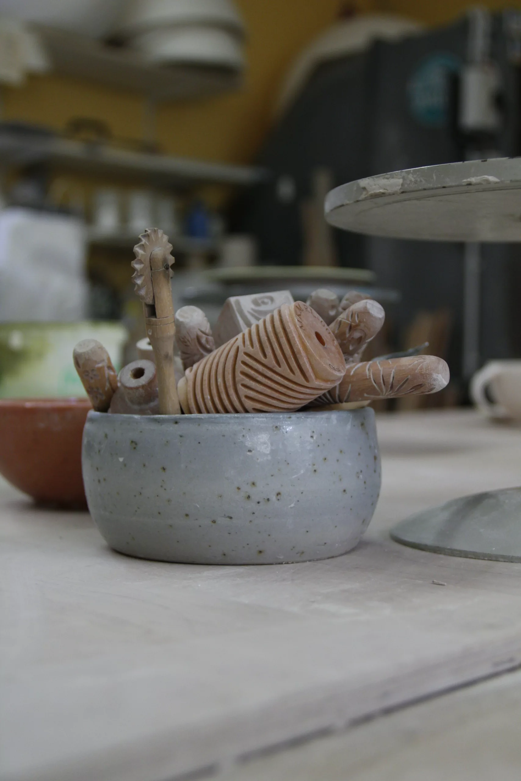 Pottery tools in a grey ceramic bowl