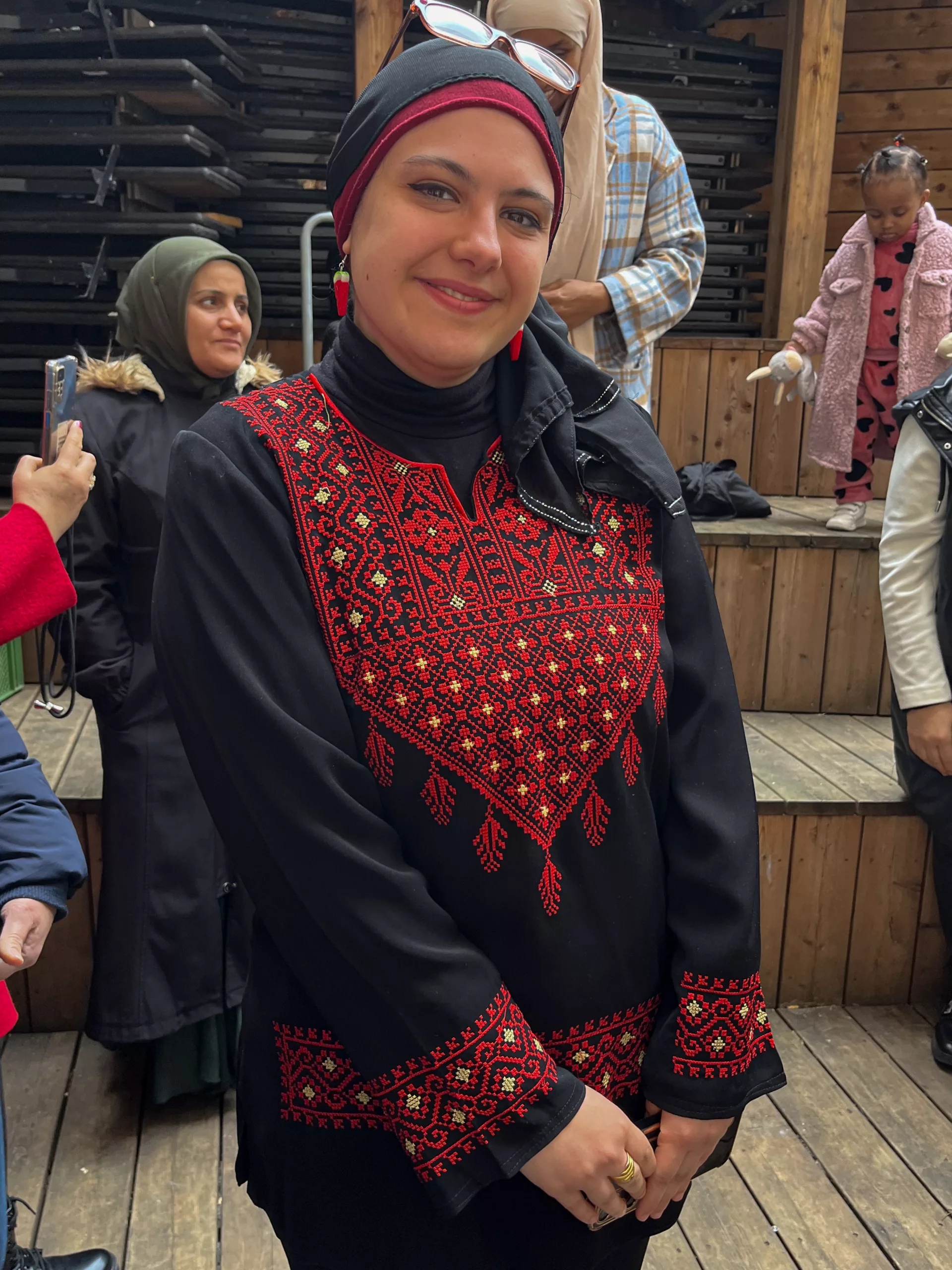 Woman in a black dress with red embroidery