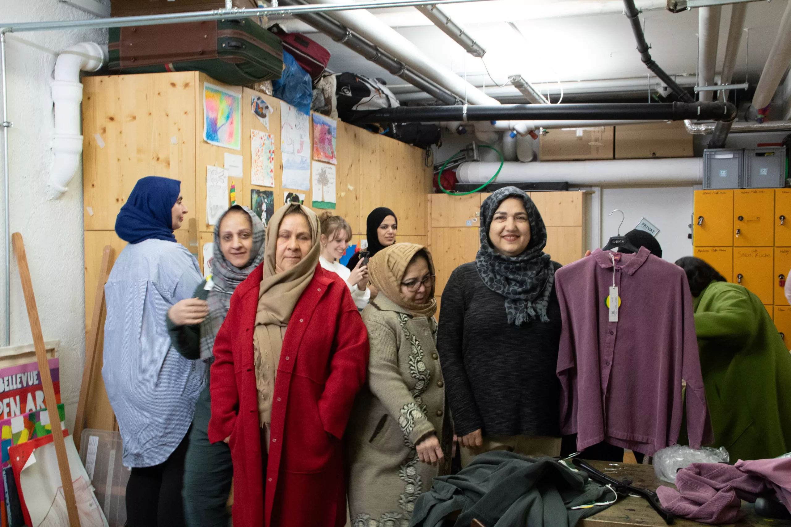 Women trying on coats at a clothes rail