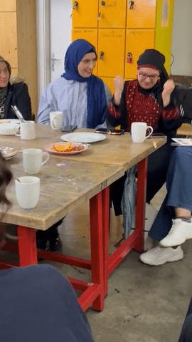 Women at the table laughing and clapping