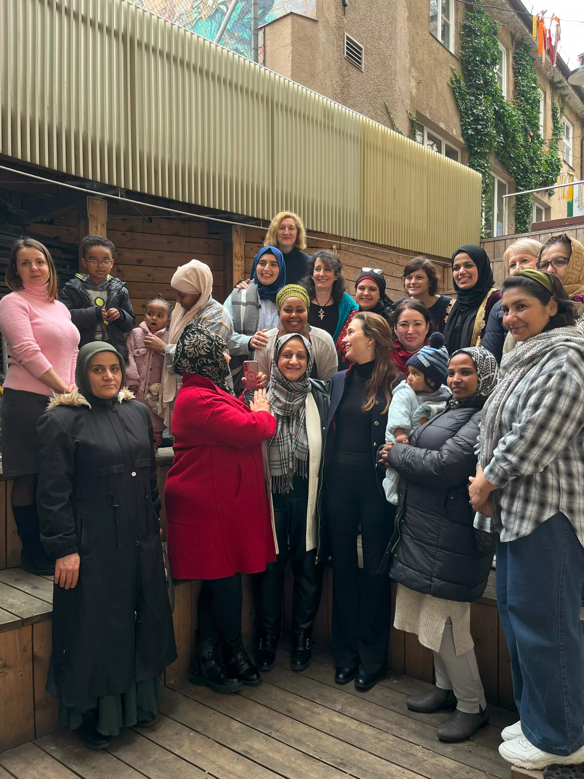 Large group of women on wooden steps in the courtyard of Bellevue di Monaco