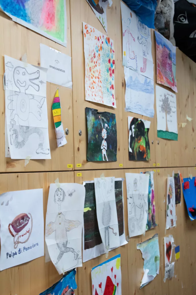 Children's drawings on a wooden wall