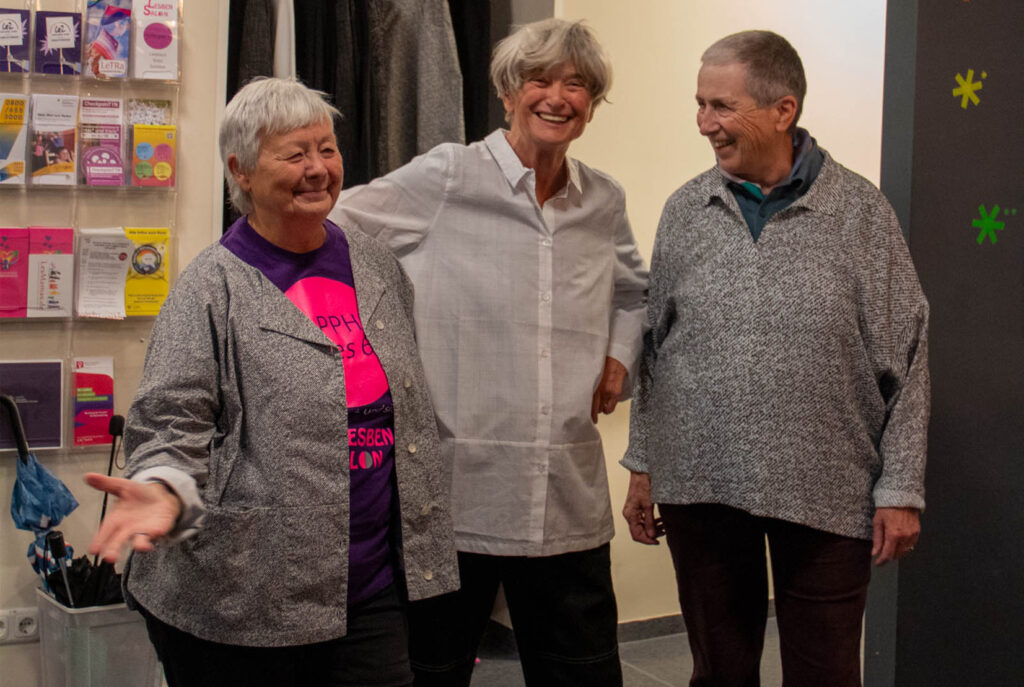 Drei Frauen lachen gemeinsam im Flur